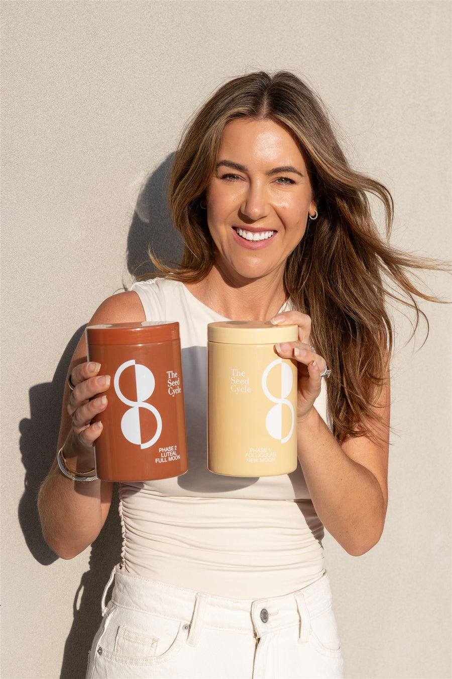 Mel Kovacevic, founder of The Seed Cycle, with seed blend jars